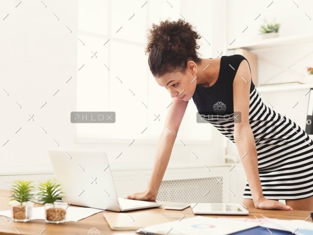demo-attachment-170-business-woman-working-on-laptop-at-office-PRFJKQJ