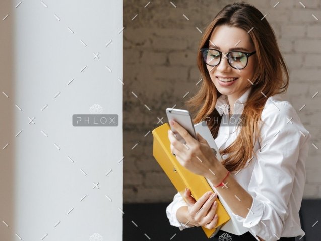 demo-attachment-175-happy-business-woman-indoors-using-mobile-phone-P9WS3SD