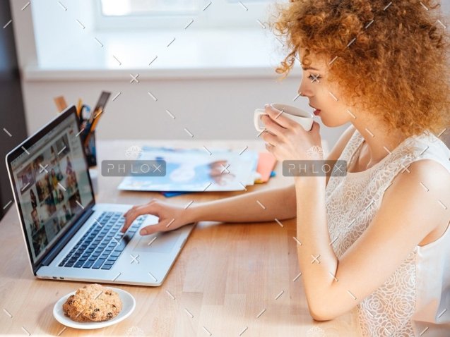 demo-attachment-177-woman-photographer-drinking-coffee-and-working-PJNBP6U